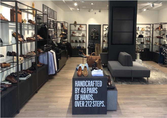 A display of shoes and clothing in a Allen Edmonds